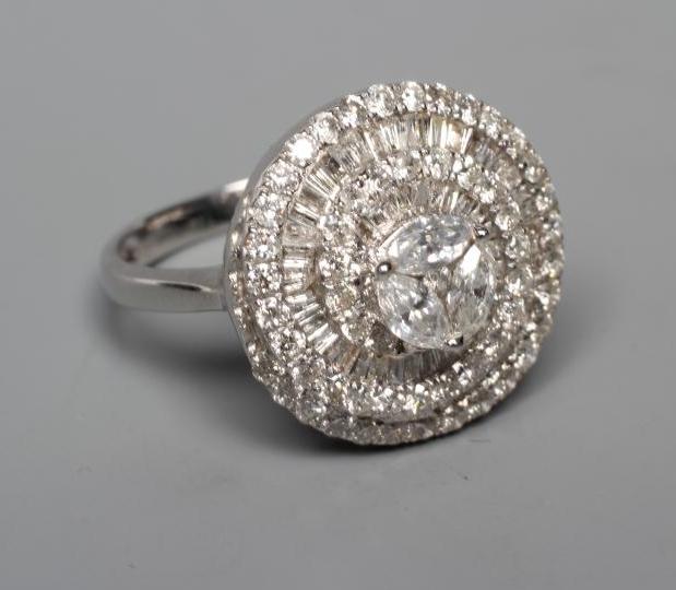A DIAMOND COCKTAIL RING centred by three pear cut stones within a spiral of point set brilliant cut Image