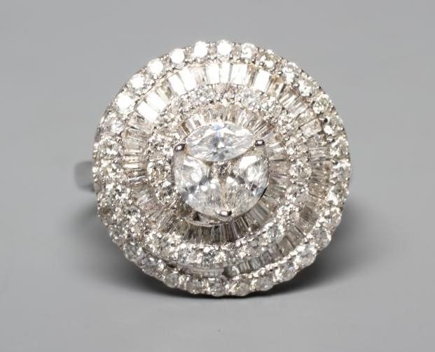 A DIAMOND COCKTAIL RING centred by three pear cut stones within a spiral of point set brilliant cut Image