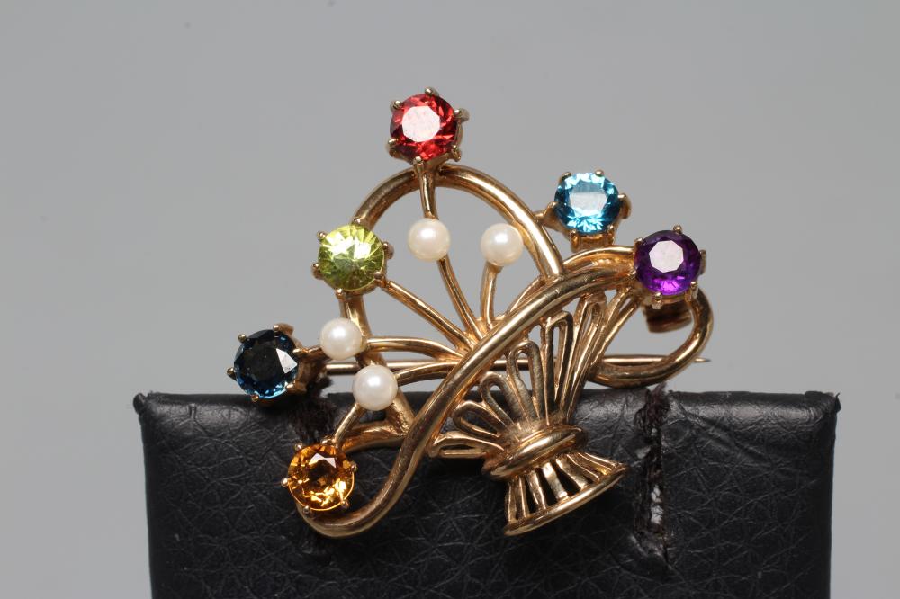 A 9CT GOLD BASKET BROOCH, claw set with facet cut semi-precious stones including an amethyst and Image