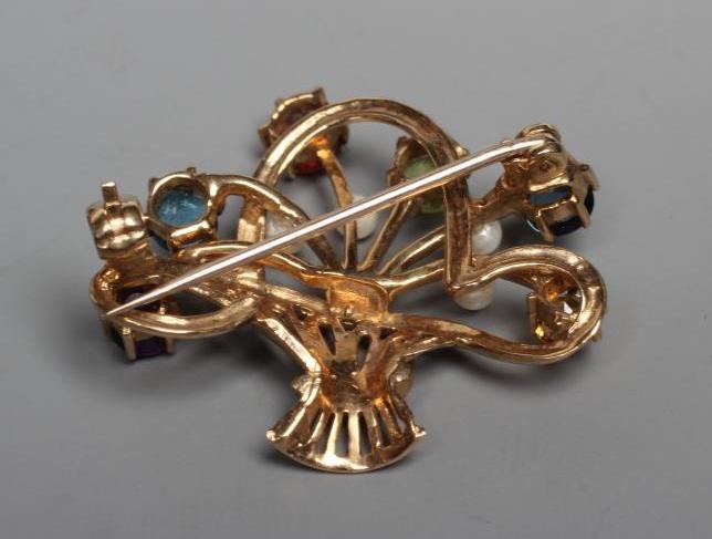 A 9CT GOLD BASKET BROOCH, claw set with facet cut semi-precious stones including an amethyst and Image