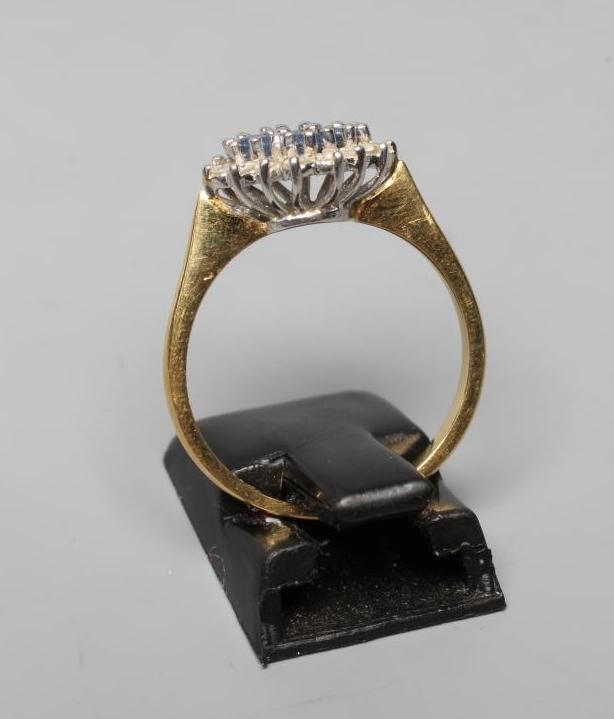 A SAPPHIRE AND DIAMOND CLUSTER RING Image