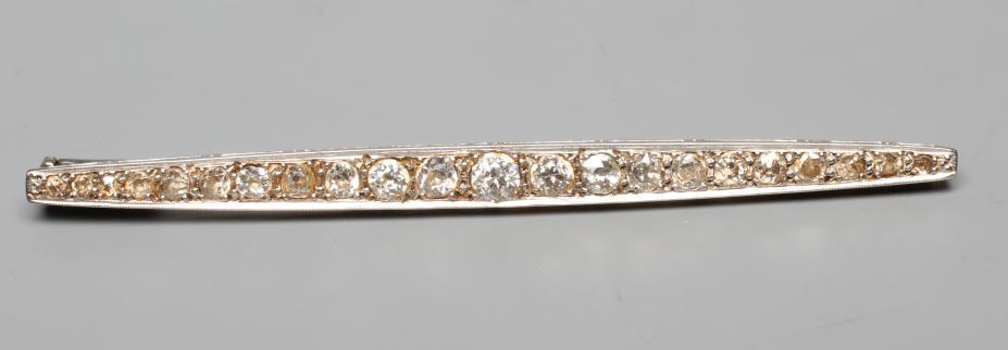A DIAMOND BROOCH, the shaped bar point set with twenty-two old cut stones to an unmarked frame (Est. Image