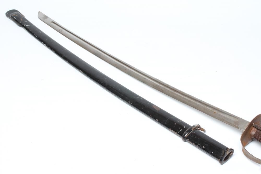 A JAPANESE 1899 PATTERN CAVALRY SWORD, the 30" blade stamped 69753, steel hand guard, wooden grip Image