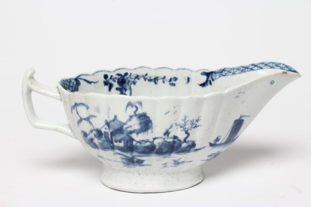 A WORCESTER PORCELAIN FRINGED TREE PATTERN SAUCEBOAT, c.1758, of fluted oval form and painted in Image