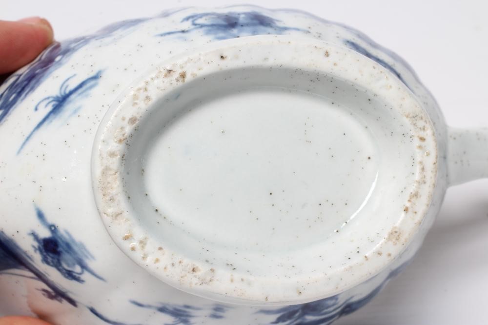 A WORCESTER PORCELAIN FRINGED TREE PATTERN SAUCEBOAT, c.1758, of fluted oval form and painted in Image