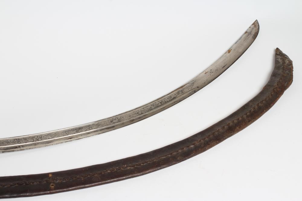 A CAVALRY OFFICER'S SABRE, the 30 1/4" curved blade etched with script within foliate scrolls, brass Image