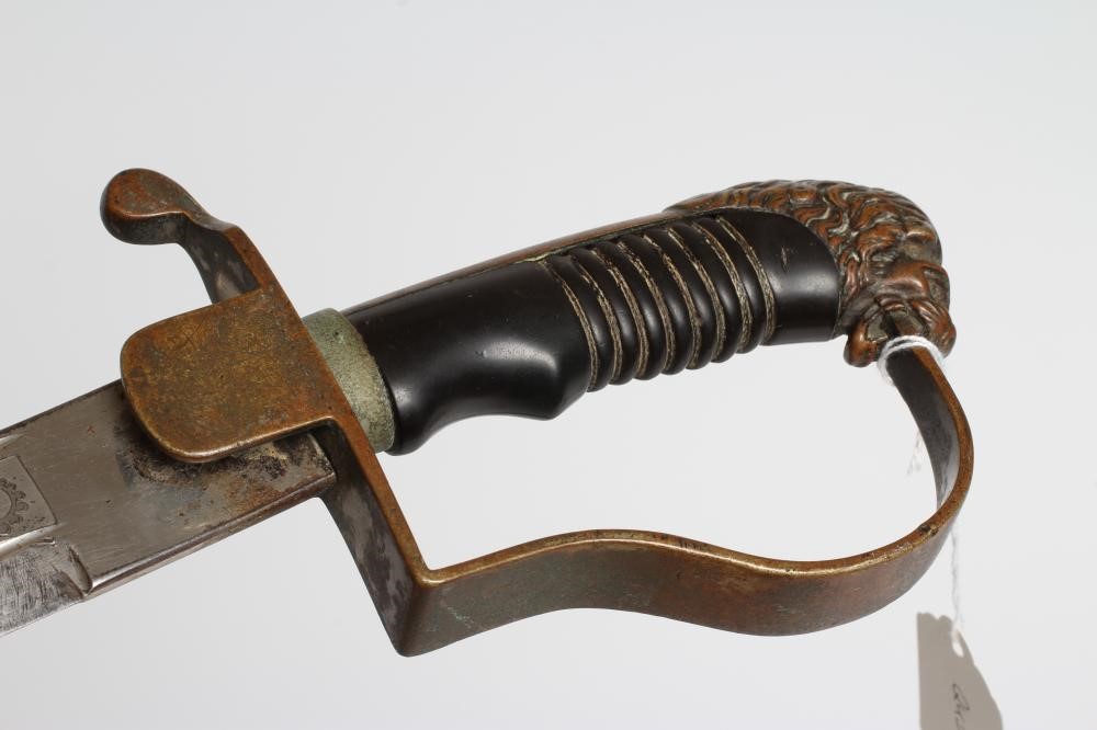A CAVALRY OFFICER'S SABRE, the 30 1/4" curved blade etched with script within foliate scrolls, brass Image