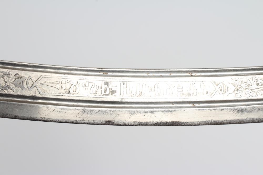 A CAVALRY OFFICER'S SABRE, the 30 1/4" curved blade etched with script within foliate scrolls, brass Image