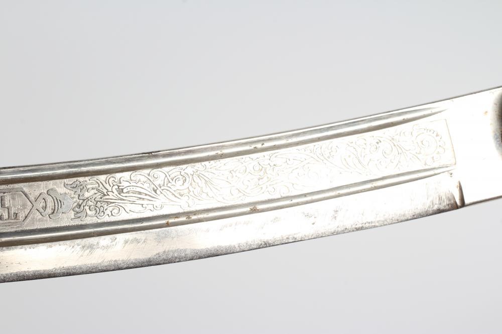 A CAVALRY OFFICER'S SABRE, the 30 1/4" curved blade etched with script within foliate scrolls, brass Image