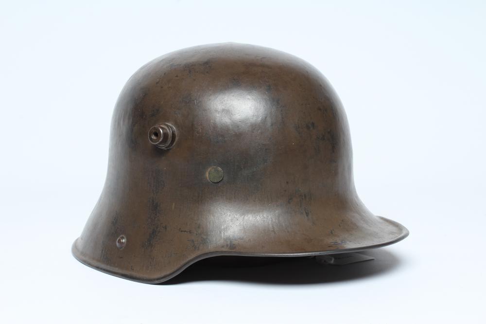 A GERMAN M16 STEEL HELMET with large external lugs and leather interior lining with strap (Est. plus Image