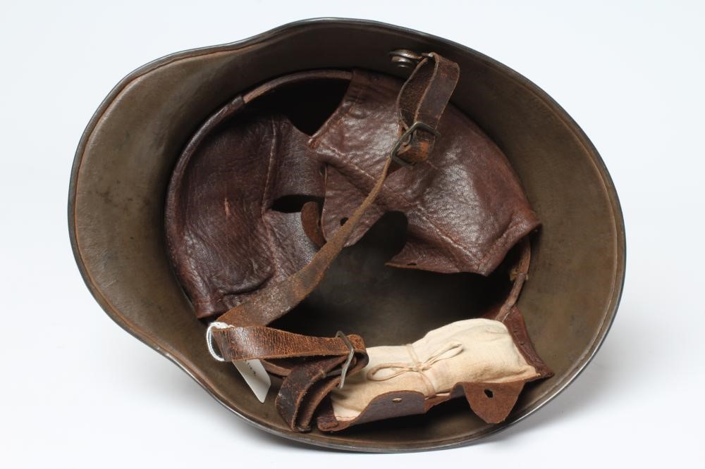 A GERMAN M16 STEEL HELMET with large external lugs and leather interior lining with strap (Est. plus Image