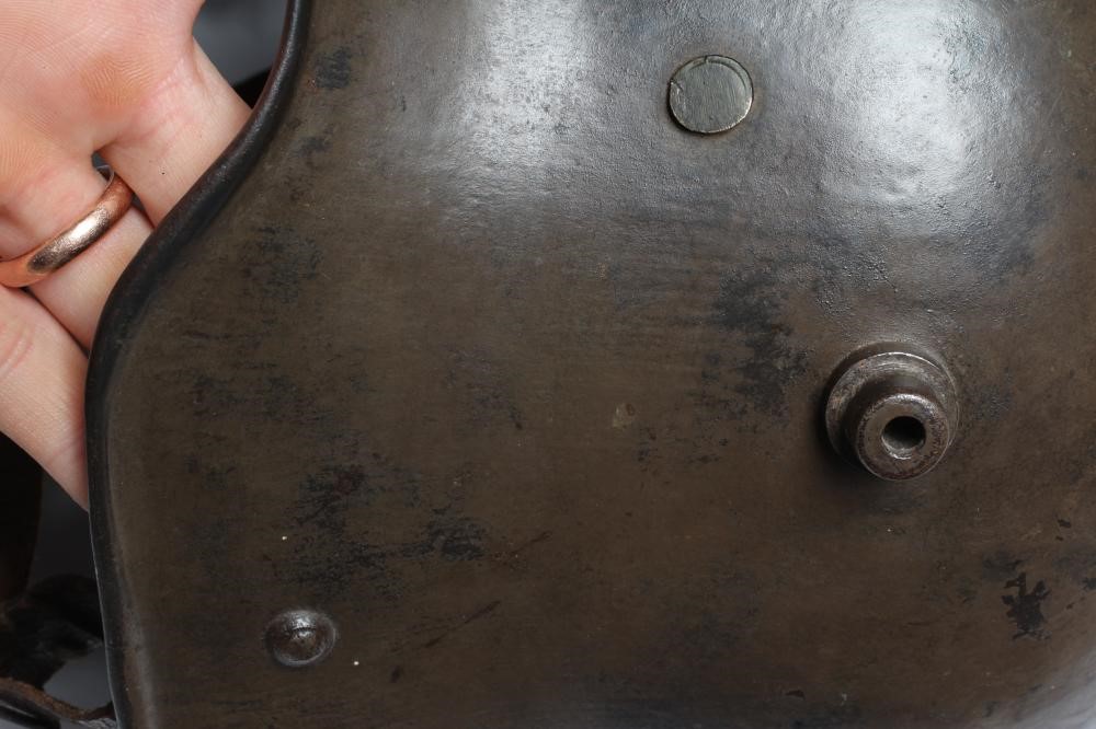 A GERMAN M16 STEEL HELMET with large external lugs and leather interior lining with strap (Est. plus Image