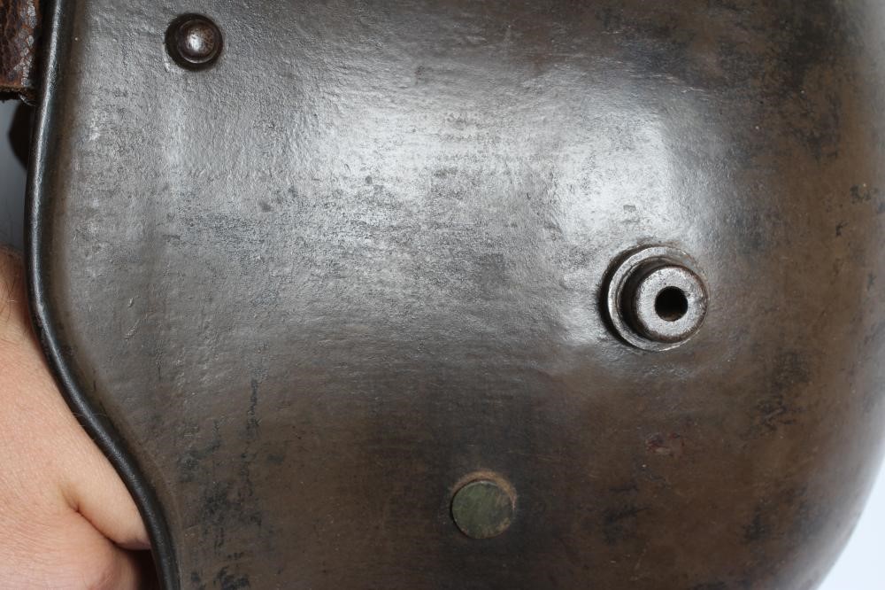 A GERMAN M16 STEEL HELMET with large external lugs and leather interior lining with strap (Est. plus Image