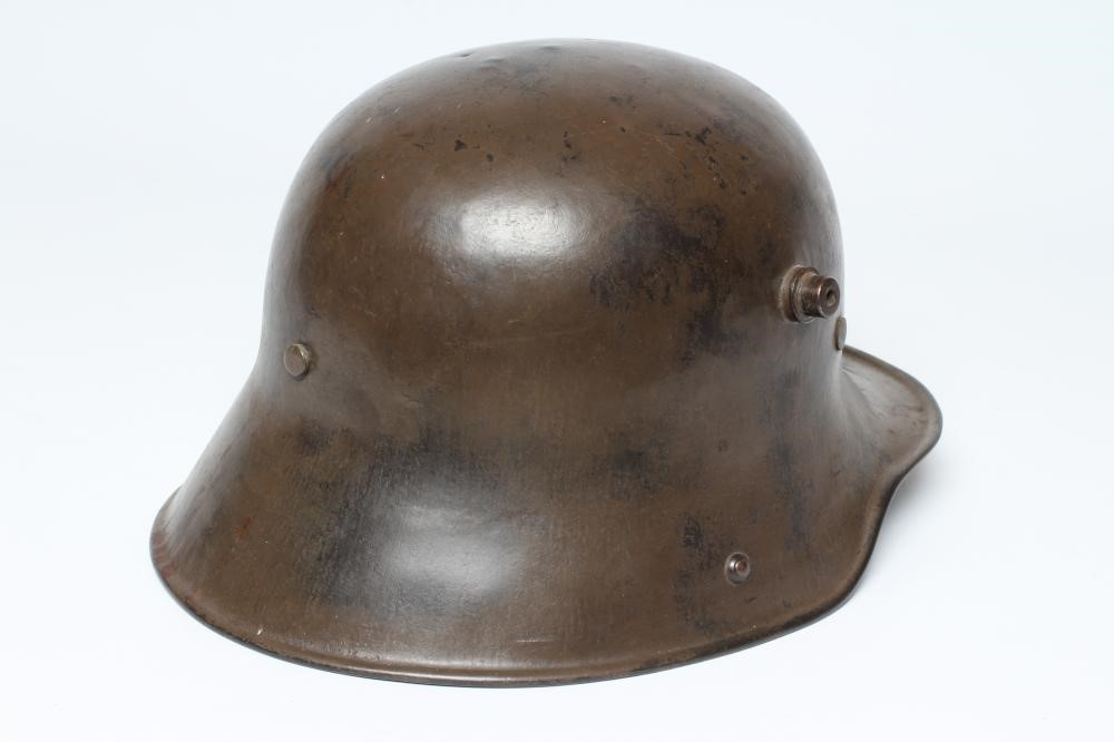 A GERMAN M16 STEEL HELMET with large external lugs and leather interior lining with strap (Est. plus Image