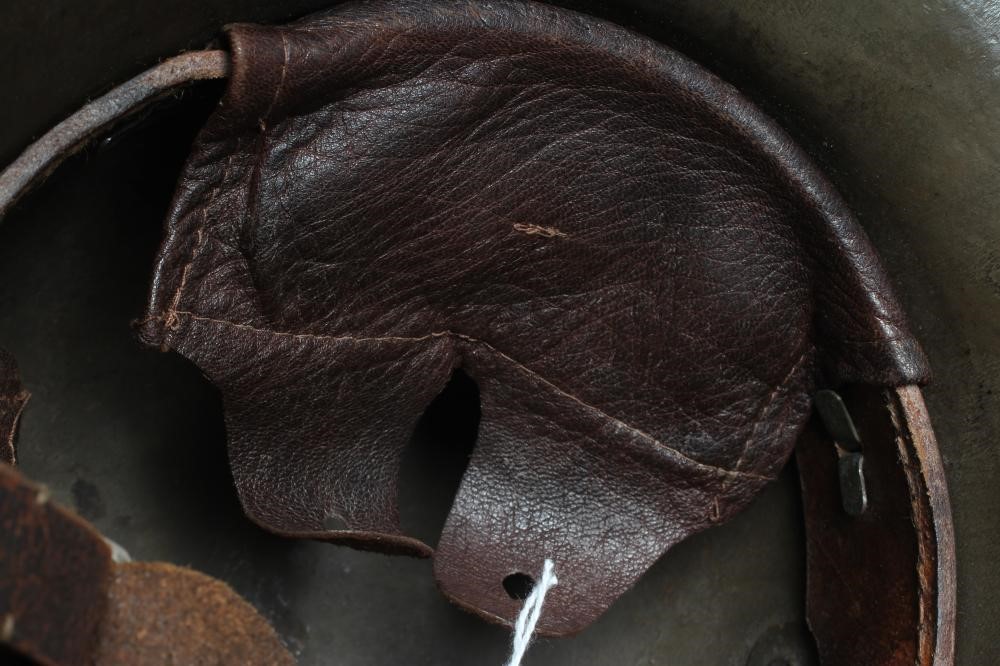 A GERMAN M16 STEEL HELMET with large external lugs and leather interior lining with strap (Est. plus Image