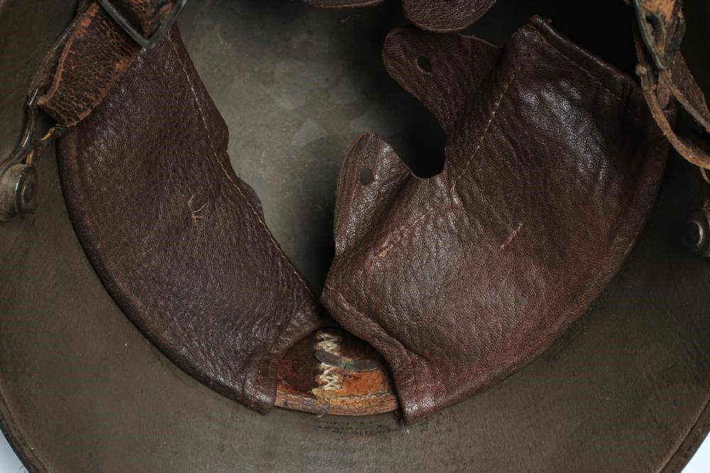 A GERMAN M16 STEEL HELMET with large external lugs and leather interior lining with strap (Est. plus Image