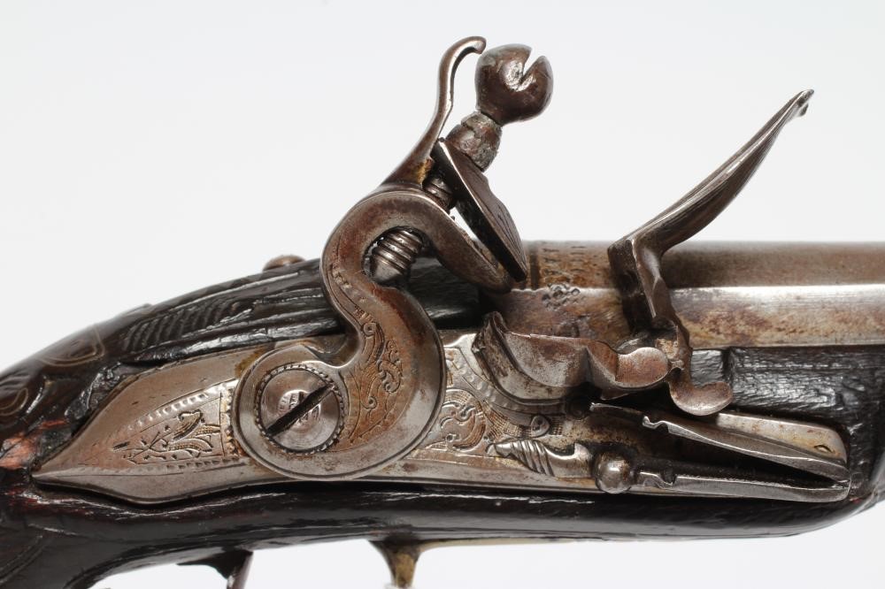 A FLINTLOCK PISTOL with 8 1/4" barrel, foliate etched lock, carved and white metal inlaid stock, Image