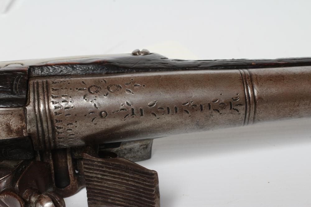 A FLINTLOCK PISTOL with 8 1/4" barrel, foliate etched lock, carved and white metal inlaid stock, Image