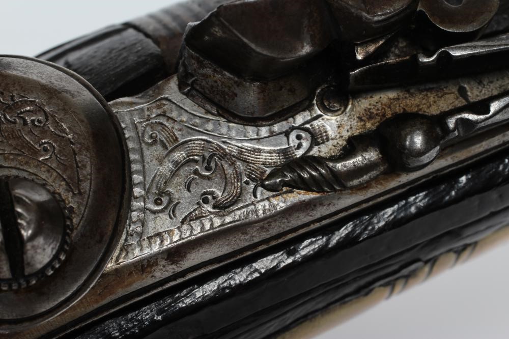 A FLINTLOCK PISTOL with 8 1/4" barrel, foliate etched lock, carved and white metal inlaid stock, Image