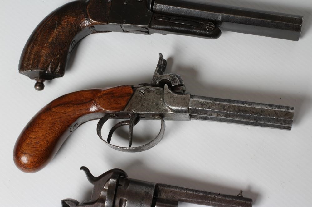 THREE ANTIQUE PISTOLS, comprising a European pinfire revolver, a double barrelled pinfire pistol and Image