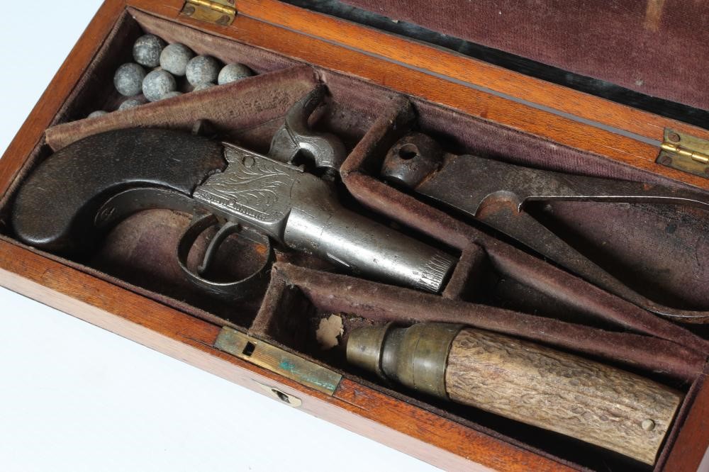 A CASED PERCUSSION POCKET PISTOL with 1 3/4" barrel, foliate etched action and walnut slab grip, 6" Image