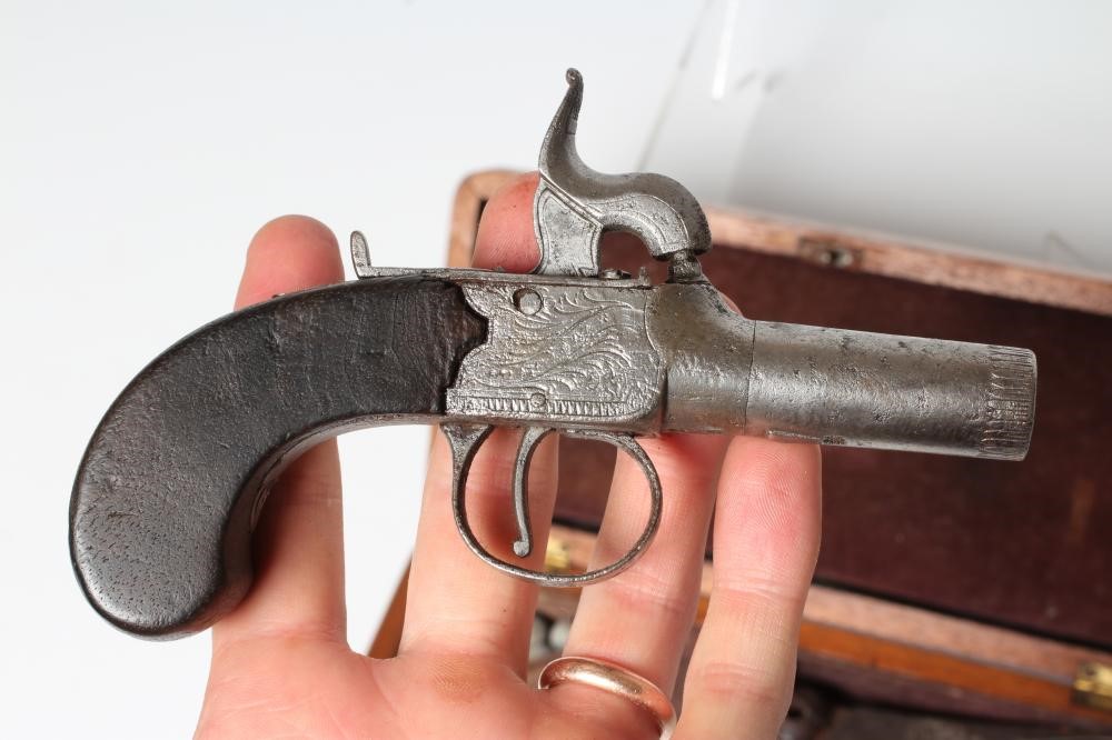 A CASED PERCUSSION POCKET PISTOL with 1 3/4" barrel, foliate etched action and walnut slab grip, 6" Image