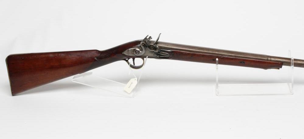 A FLINTLOCK MUSKET, the 35 3/4" barrel octagonal at the breech, stepped action, swan cock, brass Image
