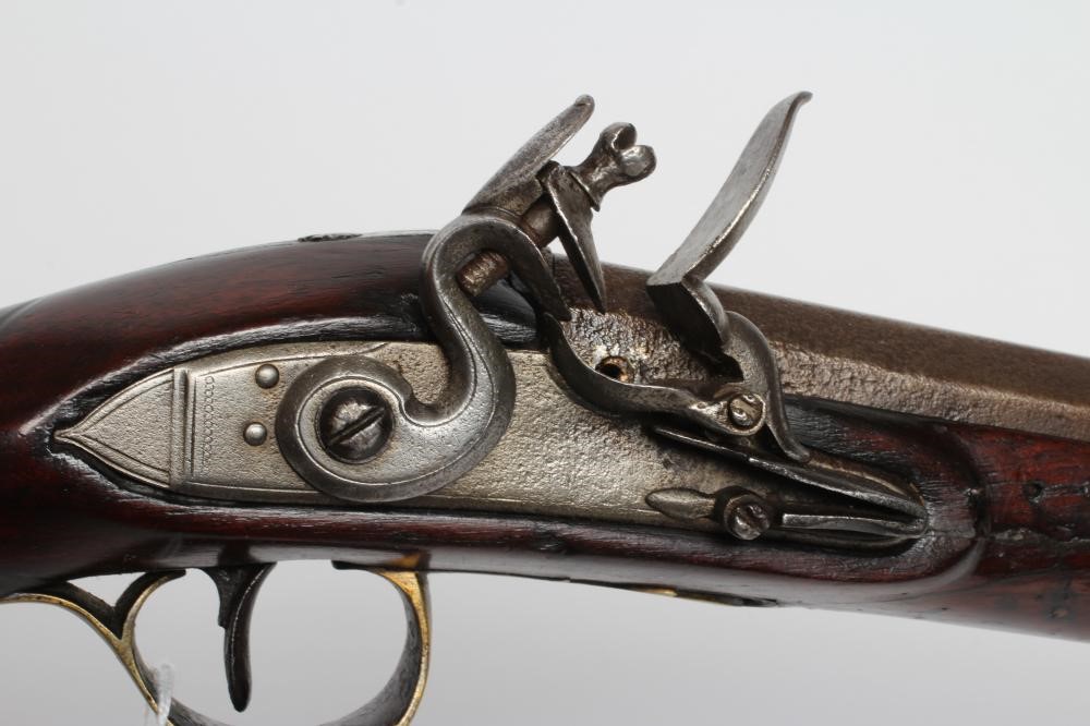 A FLINTLOCK MUSKET, the 35 3/4" barrel octagonal at the breech, stepped action, swan cock, brass Image