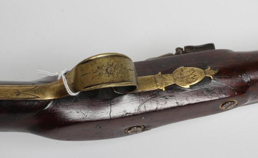 A FLINTLOCK MUSKET, the 35 3/4" barrel octagonal at the breech, stepped action, swan cock, brass Image