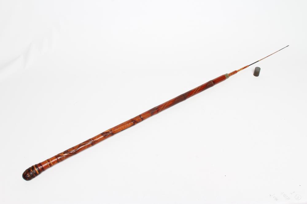 A JAPANESE TENKARA FISHING ROD WALKING CANE with carved bamboo exterior depicting a figure and an Image