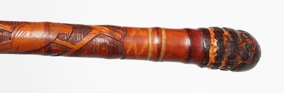 A JAPANESE TENKARA FISHING ROD WALKING CANE with carved bamboo exterior depicting a figure and an Image