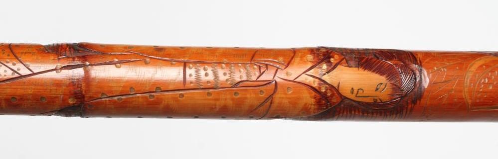 A JAPANESE TENKARA FISHING ROD WALKING CANE with carved bamboo exterior depicting a figure and an Image