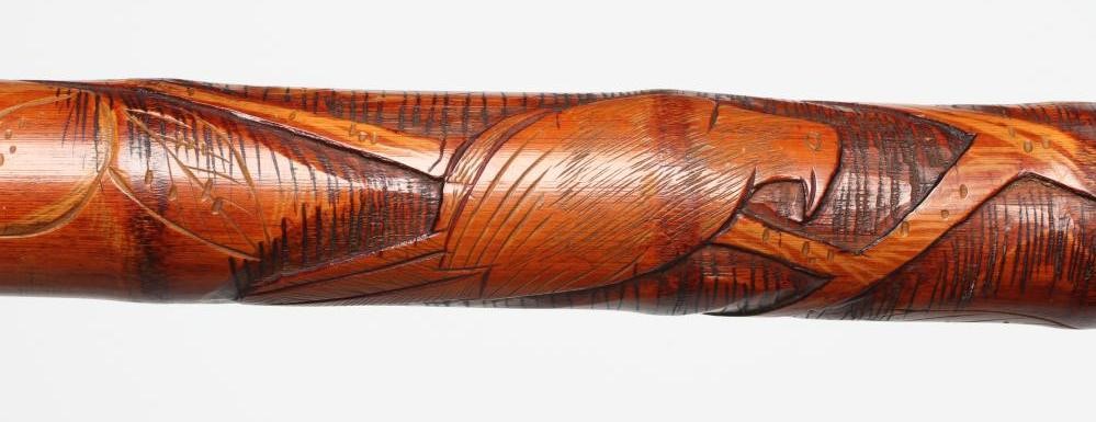 A JAPANESE TENKARA FISHING ROD WALKING CANE with carved bamboo exterior depicting a figure and an Image