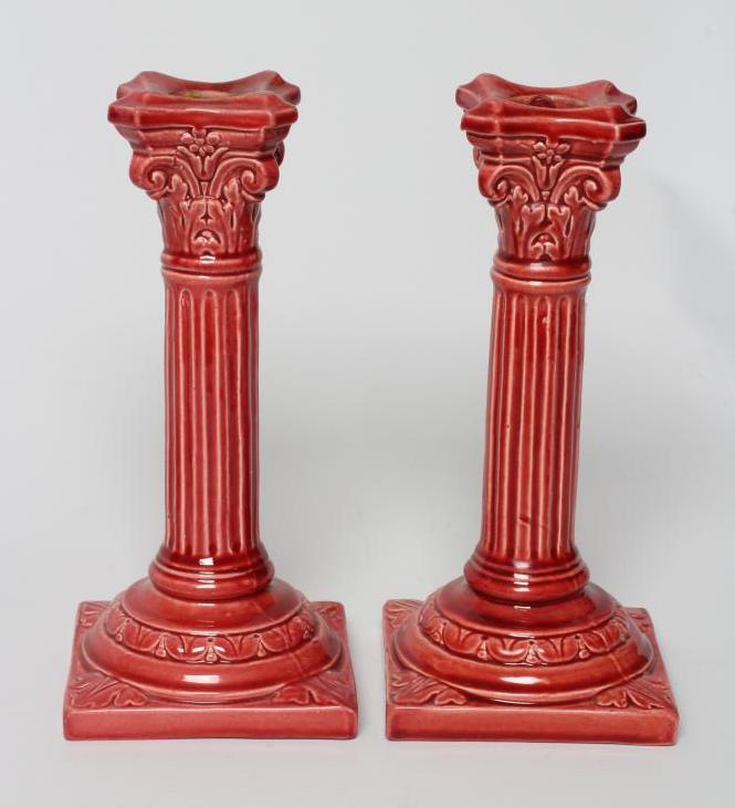 A PAIR OF BURMANTOFTS PINK GLAZED FAIENCE CORINTHIAN COLUMN CANDLESTICKS, c.1900, with fixed sconces Image