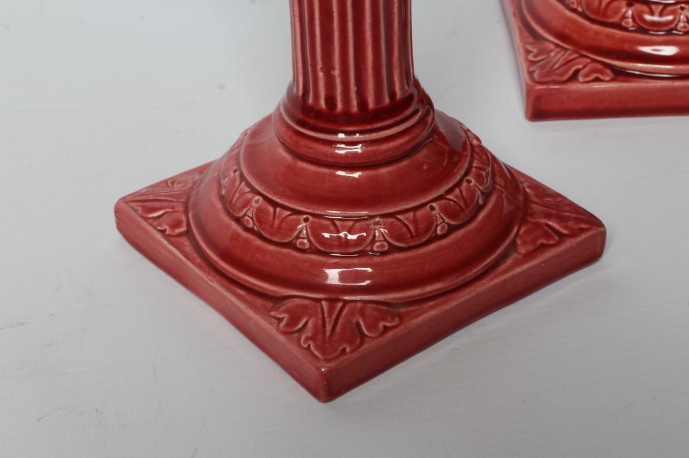 A PAIR OF BURMANTOFTS PINK GLAZED FAIENCE CORINTHIAN COLUMN CANDLESTICKS, c.1900, with fixed sconces Image
