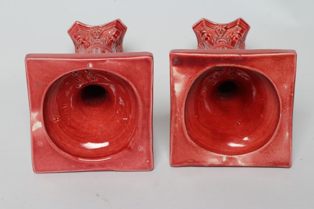 A PAIR OF BURMANTOFTS PINK GLAZED FAIENCE CORINTHIAN COLUMN CANDLESTICKS, c.1900, with fixed sconces Image