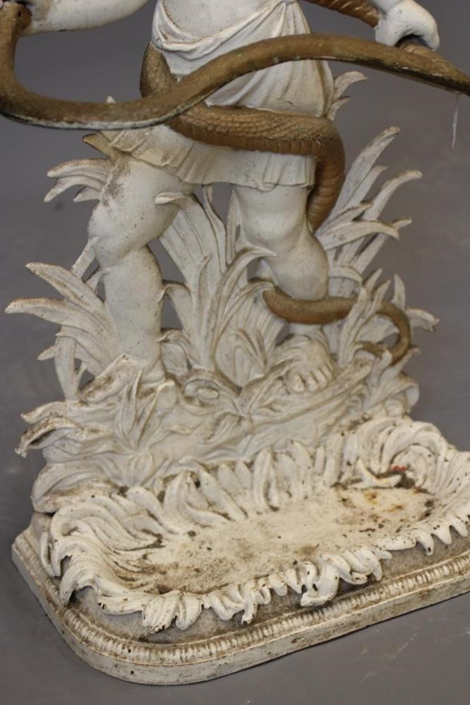 A VICTORIAN CAST IRON STICK STAND modelled as young Hercules with serpent, the base with leaf Image