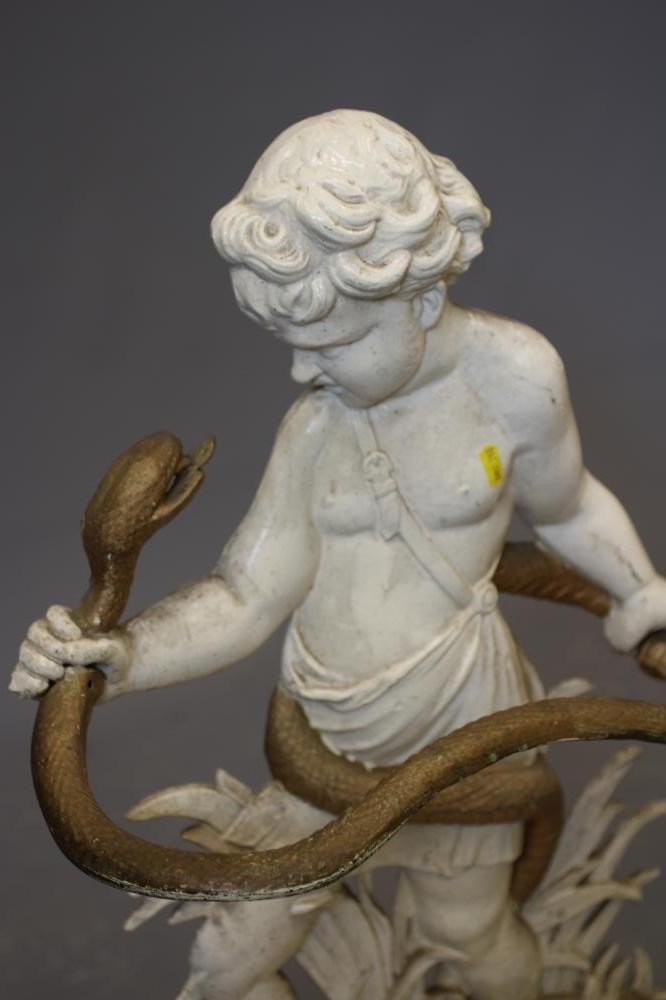 A VICTORIAN CAST IRON STICK STAND modelled as young Hercules with serpent, the base with leaf Image
