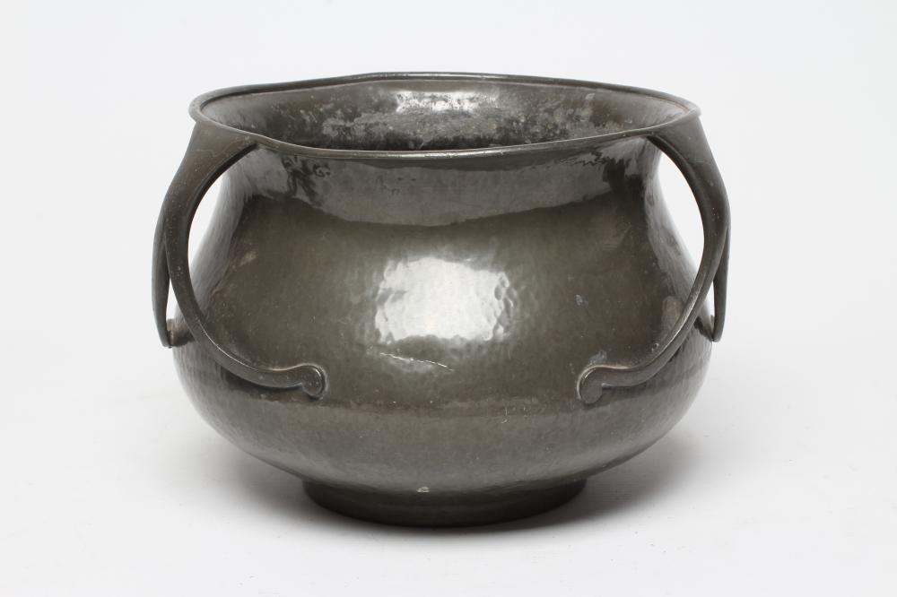 A LIBERTY AND CO. PEWTER JARDINIERE of planished baluster form with everted rim and three bifurcated Image