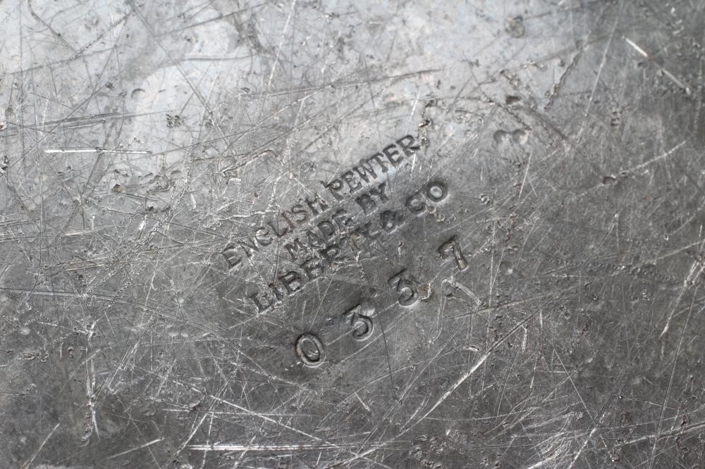 A LIBERTY AND CO. PEWTER JARDINIERE of planished baluster form with everted rim and three bifurcated Image