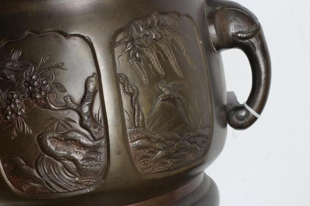 A CHINESE BRONZE JARDINIERE, c.1900, of circular form with flared rim and elephant mask handles, Image