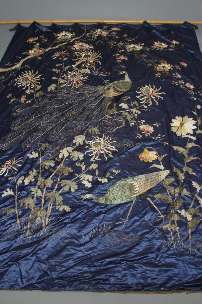 A LARGE CHINESE BLUE SILK PANEL embroidered in coloured silks with a pair of peacocks amidst Image