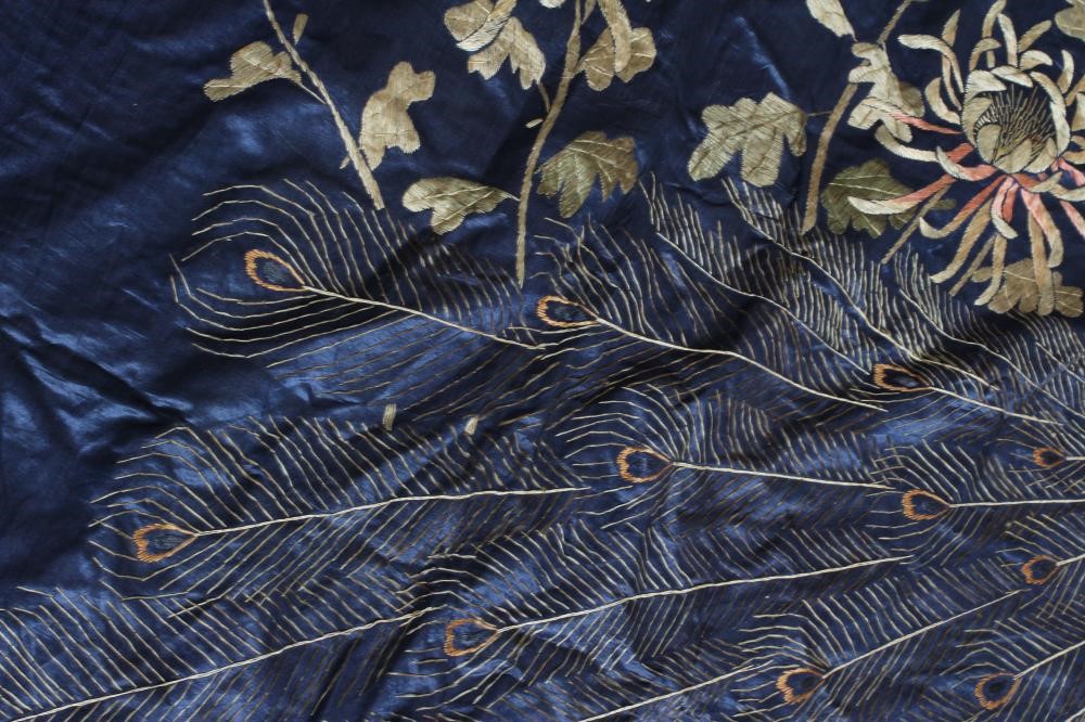 A LARGE CHINESE BLUE SILK PANEL embroidered in coloured silks with a pair of peacocks amidst Image