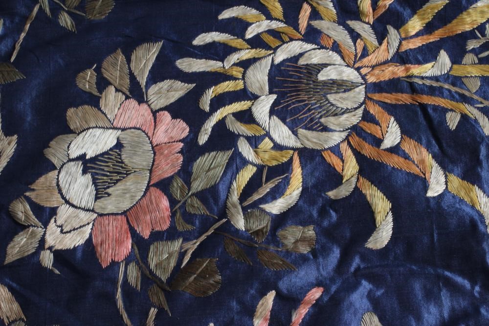 A LARGE CHINESE BLUE SILK PANEL embroidered in coloured silks with a pair of peacocks amidst Image