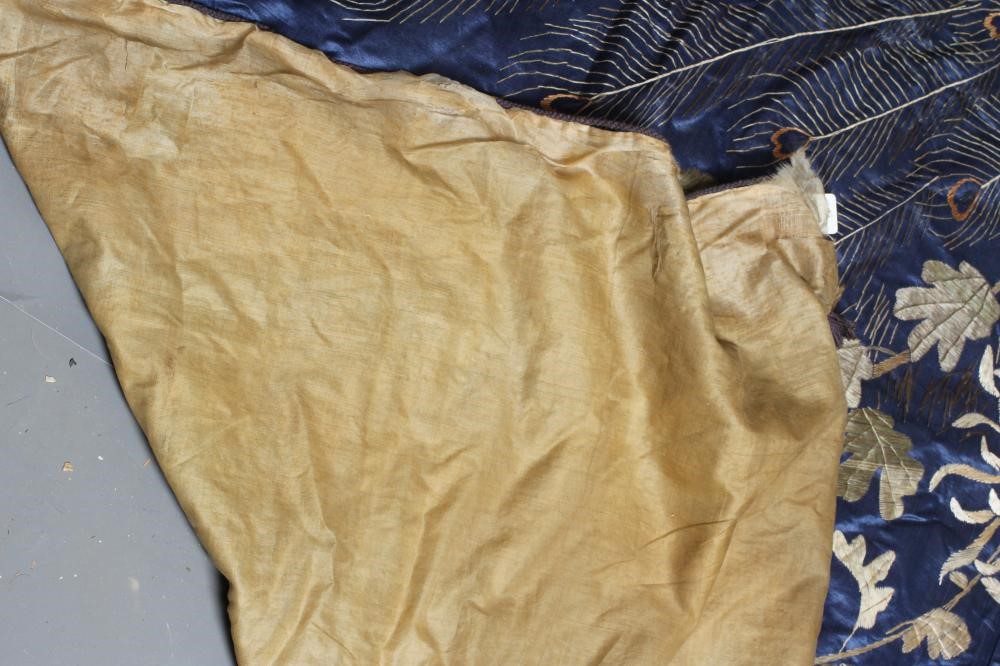 A LARGE CHINESE BLUE SILK PANEL embroidered in coloured silks with a pair of peacocks amidst Image