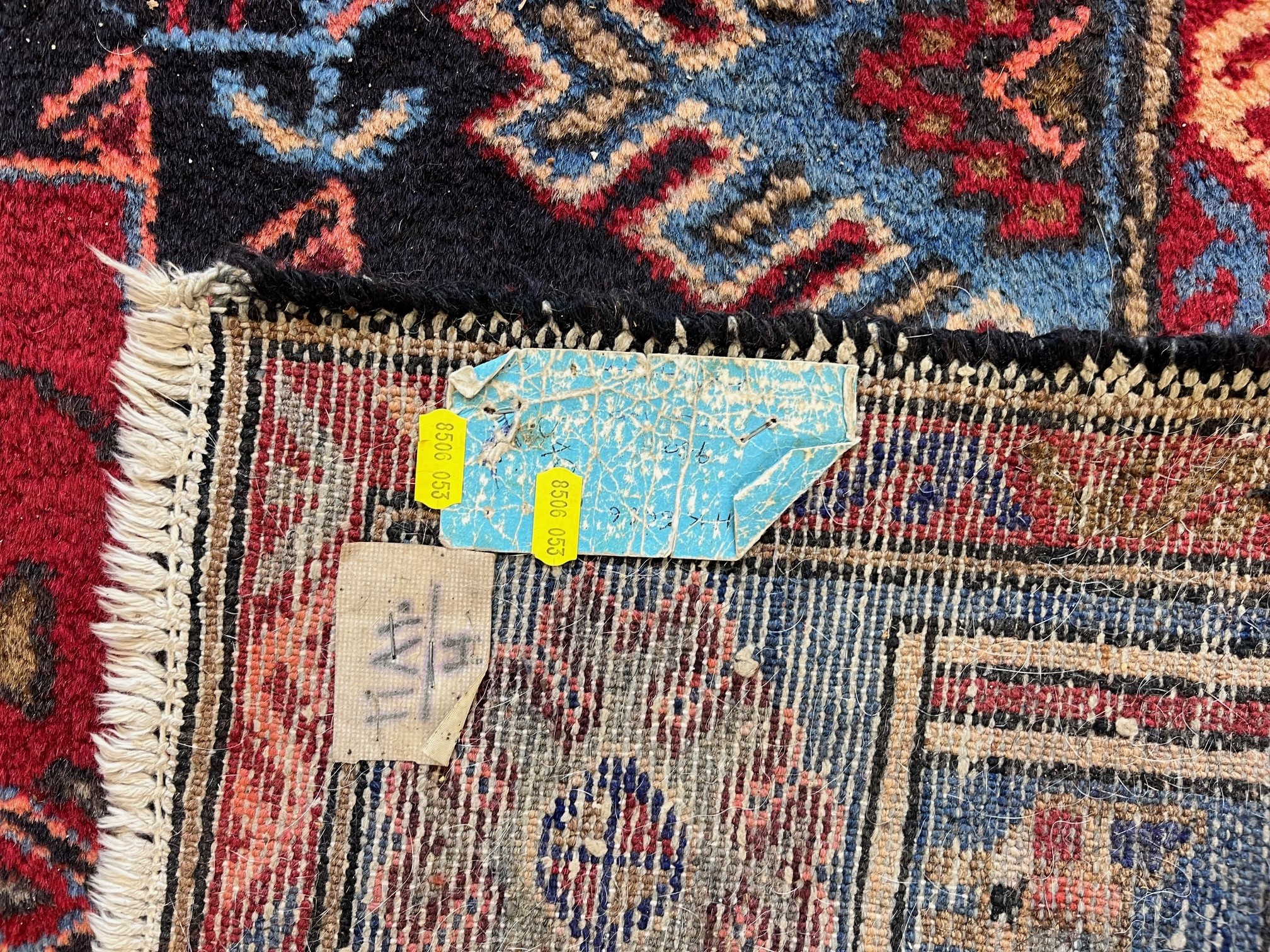 A PERSIAN STYLE WOOL RUG, modern, the black field with large claret red gul and sky blue spandrels, Image