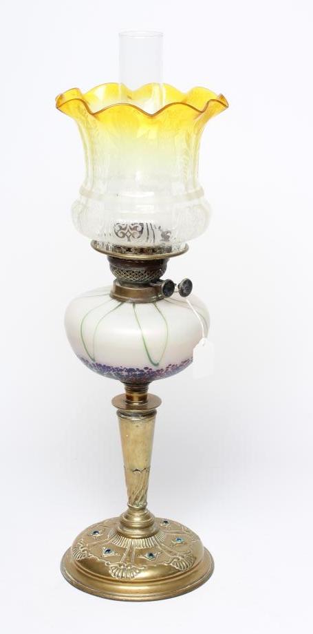 AN EDWARDIAN ART NOUVEAU DOUBLE WICK OIL LAMP with glass reservoir and etched flared glass shade on Image