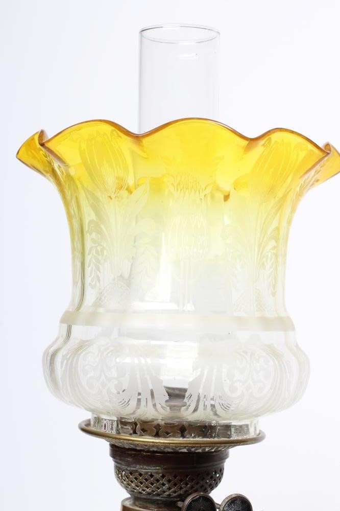 AN EDWARDIAN ART NOUVEAU DOUBLE WICK OIL LAMP with glass reservoir and etched flared glass shade on Image