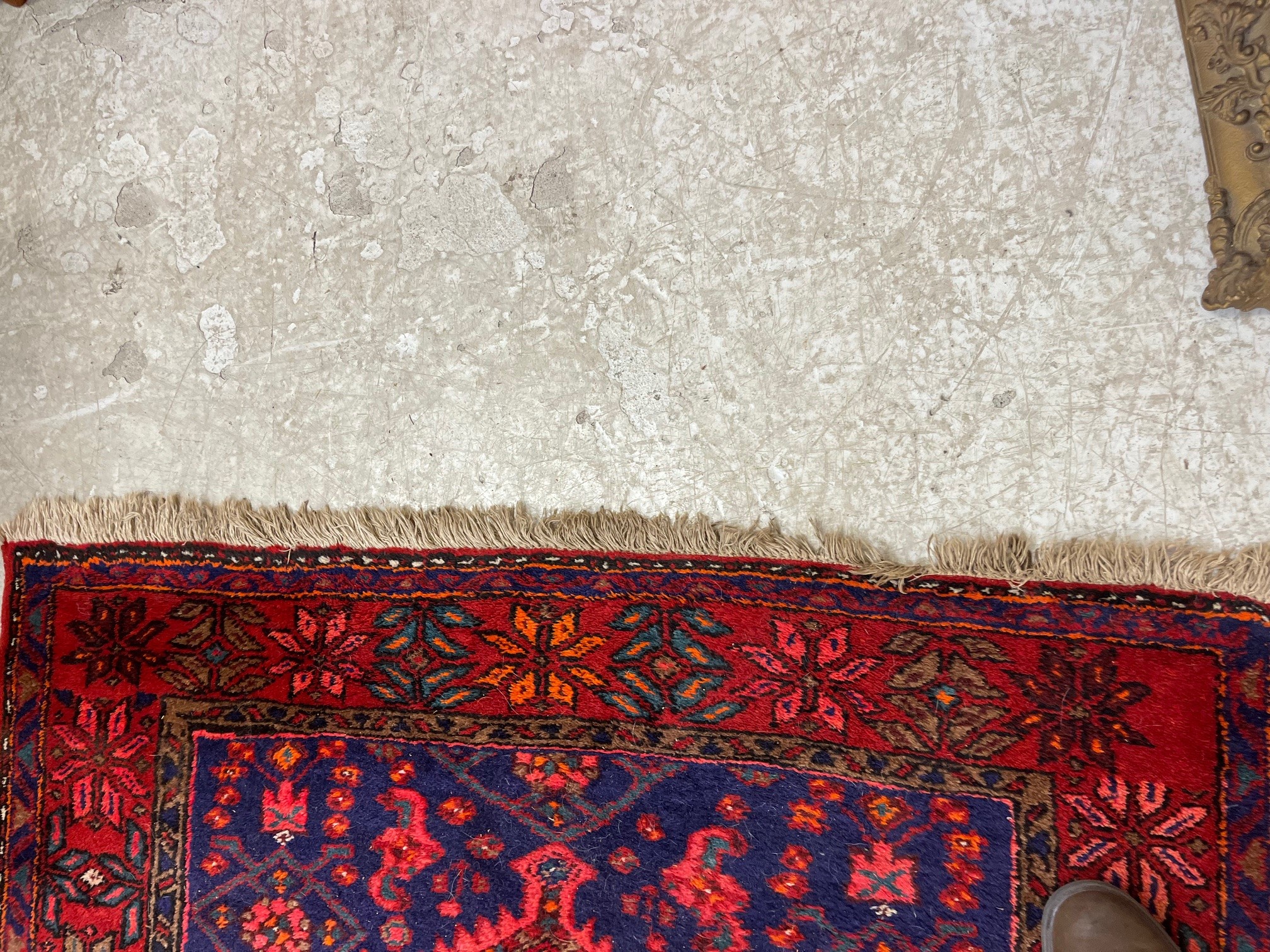 A PERSIAN STYLE WOOL RUG, modern, the burgundy floral field with indigo gul and spandrels, within a Image