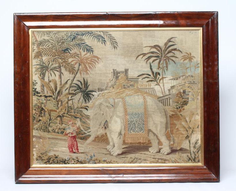 A VICTORIAN WOOLWORK PICTURE worked in half cross stitch with an elephant and its mahout in a Image
